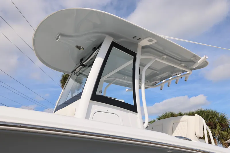 Slide: The Image of 2026 Sea Hunt Ultra 265 SE boat with sleek T-top design against blue sky. - 27