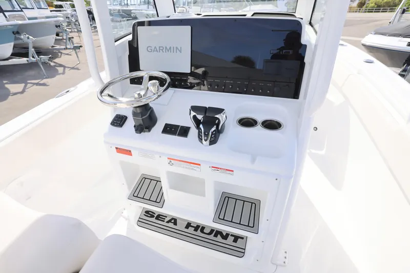 Slide: The Image of 2026 Sea Hunt Ultra 265 SE boat console with Garmin display and steering wheel. - 3