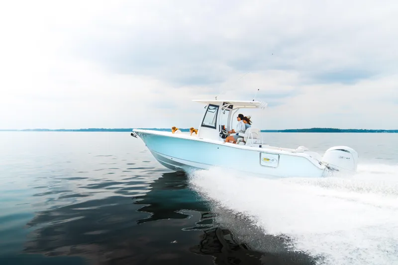 Slide: The Image of 2025 Sea Hunt Ultra 265 SE boat cruising on calm waters. - 31