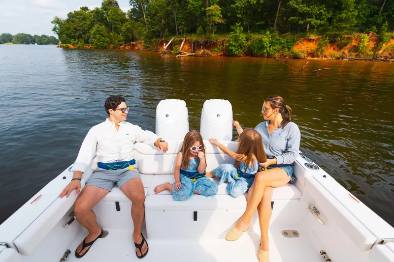 Slide: The Image of Family enjoying a day on a 2025 Sea Hunt Ultra 265 SE boat. - 32