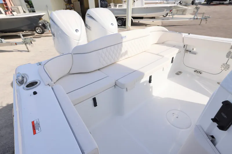 Slide: The Image of 2026 Sea Hunt Ultra 265 SE boat interior with white cushioned seating and dual engines. - 5