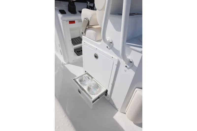 Slide: The Image of 2026 Sea Hunt Ultra 265 SE boat interior with open storage drawer. - 8