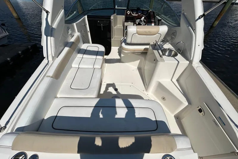 Slide: The Image of Interior cabin of 2010 Sea Ray Sundancer 260 with beige carpeting and cushions. - 100