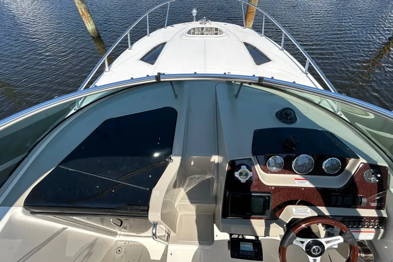 Slide: The Image of Interior compartment of 2010 Sea Ray Sundancer 260 with warning label and toilet paper holder. - 108