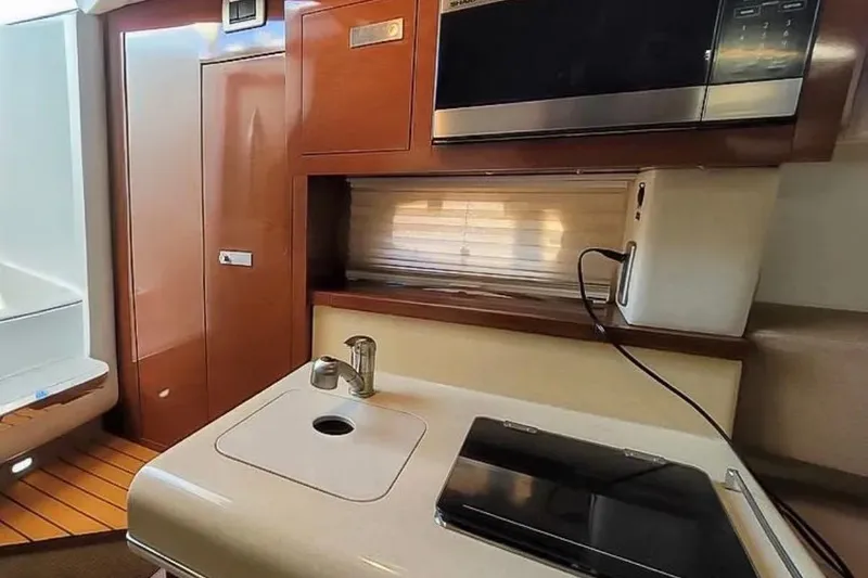Slide: The Image of Interior of 2010 Sea Ray Sundancer 260 with kitchenette and microwave. - 11