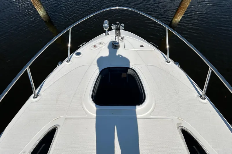Slide: The Image of Wooden panel with a metallic handle on a 2010 Sea Ray Sundancer 260 boat. - 112