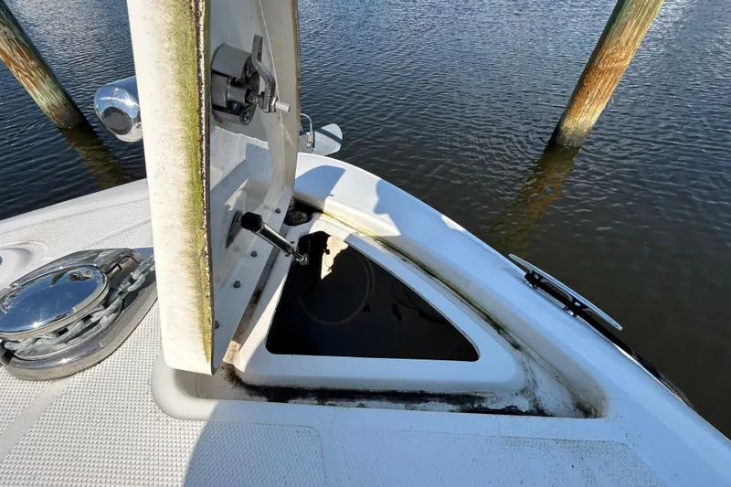 Slide: The Image of Interior view of 2010 Sea Ray Sundancer 260 cabin with window and wooden finish. - 115