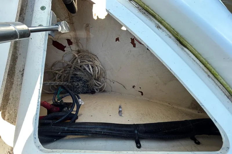 Slide: The Image of Open wooden cabinet in 2010 Sea Ray Sundancer 260 boat interior. - 116