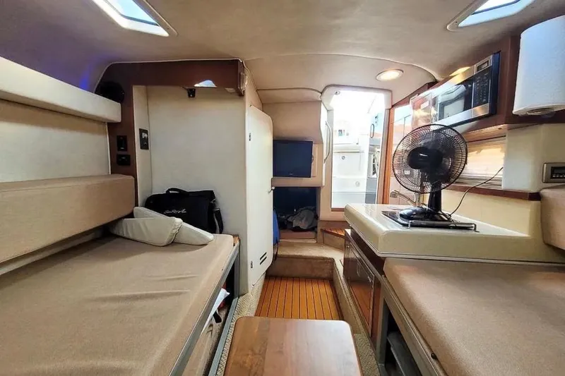 Slide: The Image of Interior of 2010 Sea Ray Sundancer 260 boat with cozy seating and modern amenities. - 12