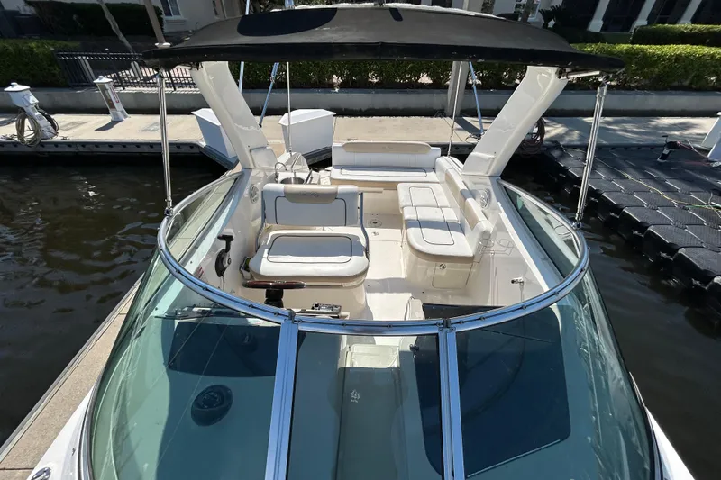 Slide: The Image of Open mini fridge on 2010 Sea Ray Sundancer 260 boat, showcasing interior storage space. - 124