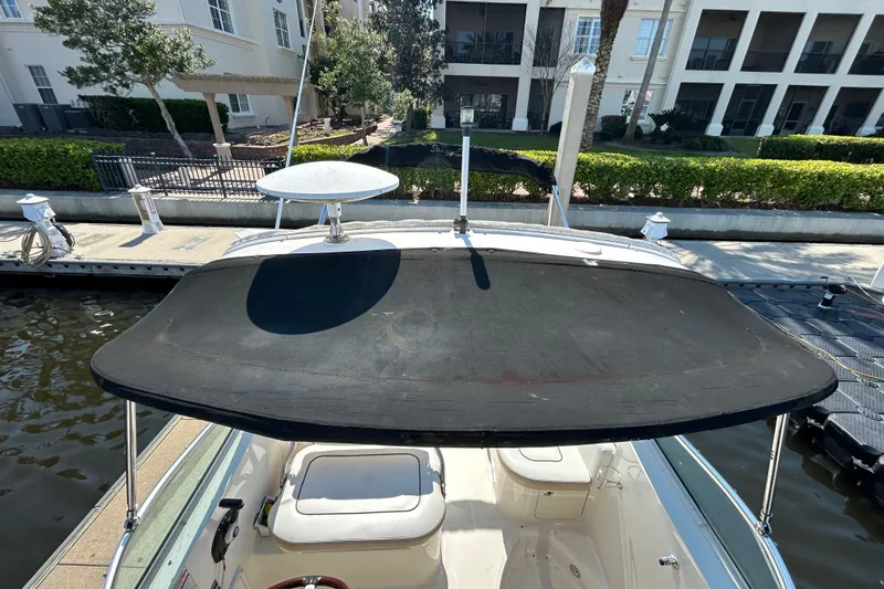 Slide: The Image of Interior detail of a 2010 Sea Ray Sundancer 260, featuring wood cabinetry and stainless steel accents. - 125