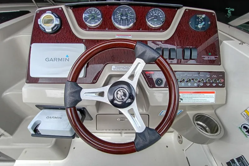 Slide: The Image of Dashboard of 2010 Sea Ray Sundancer 260 with Garmin navigation and wood-trimmed steering wheel. - 20