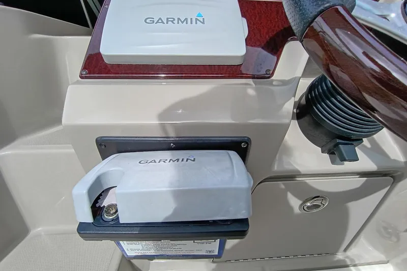 Slide: The Image of Garmin device on 2010 Sea Ray Sundancer 260 dashboard, featuring a wooden steering wheel. - 21