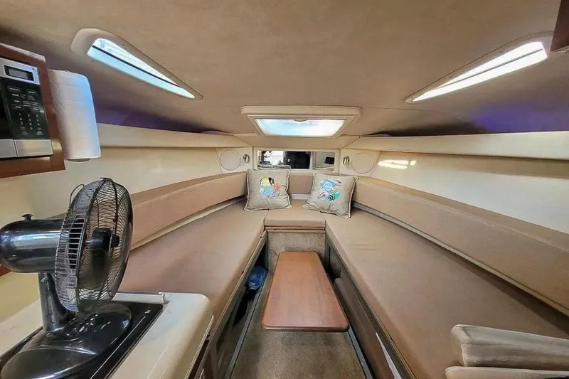 Slide: The Image of Interior of 2010 Sea Ray Sundancer 260 cabin with seating, table, and fan. - 35