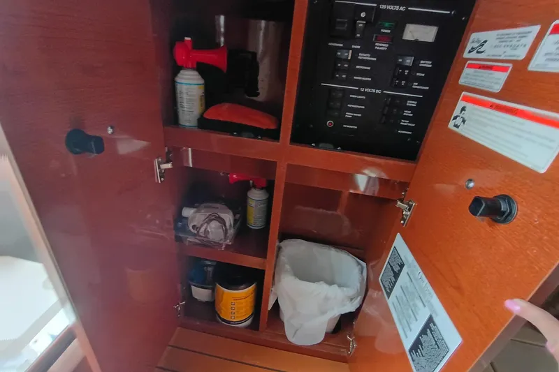 Slide: The Image of Cabinet interior of 2010 Sea Ray Sundancer 260 with safety equipment and control panel. - 39