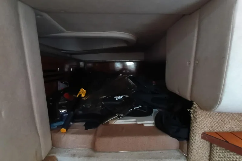 Slide: The Image of Interior cabin of 2010 Sea Ray Sundancer 260 with stored items. - 41
