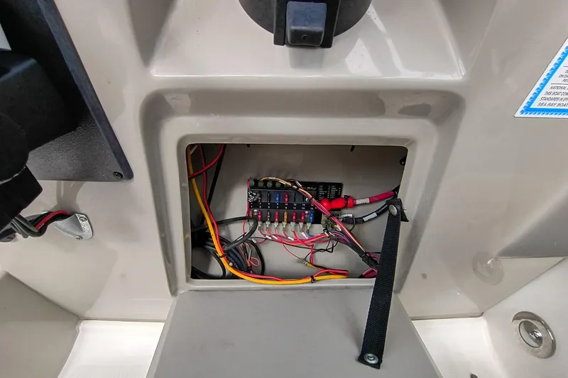 Slide: The Image of Electrical panel inside a 2010 Sea Ray Sundancer 260 boat, showing wiring and fuses. - 47