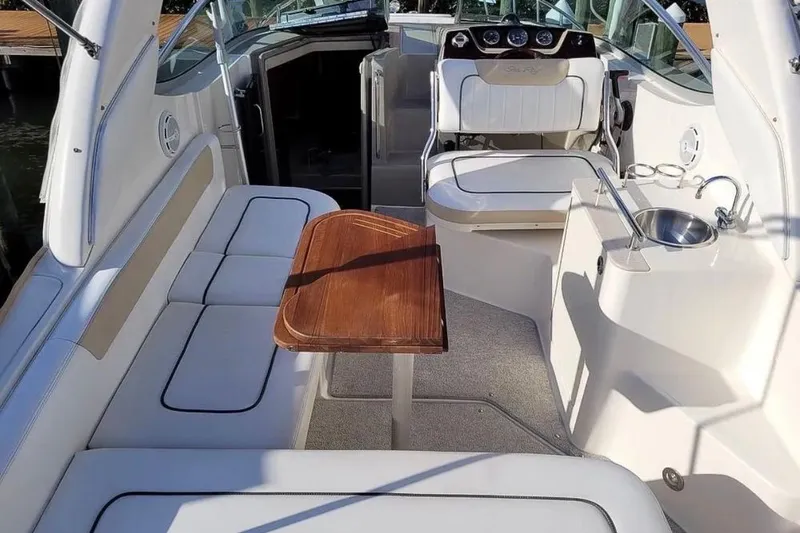 Slide: The Image of 2010 Sea Ray Sundancer 260 interior with seating, table, and sink. - 5