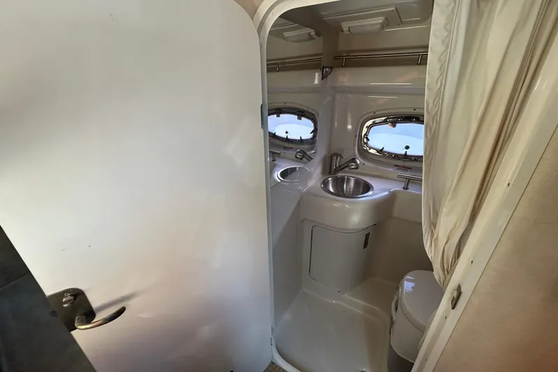 Slide: The Image of Engine compartment of 2010 Sea Ray Sundancer 260 with batteries and wiring. - 58