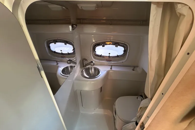 Slide: The Image of 2010 Sea Ray Sundancer 260 boat interior with sink and seating area. - 59