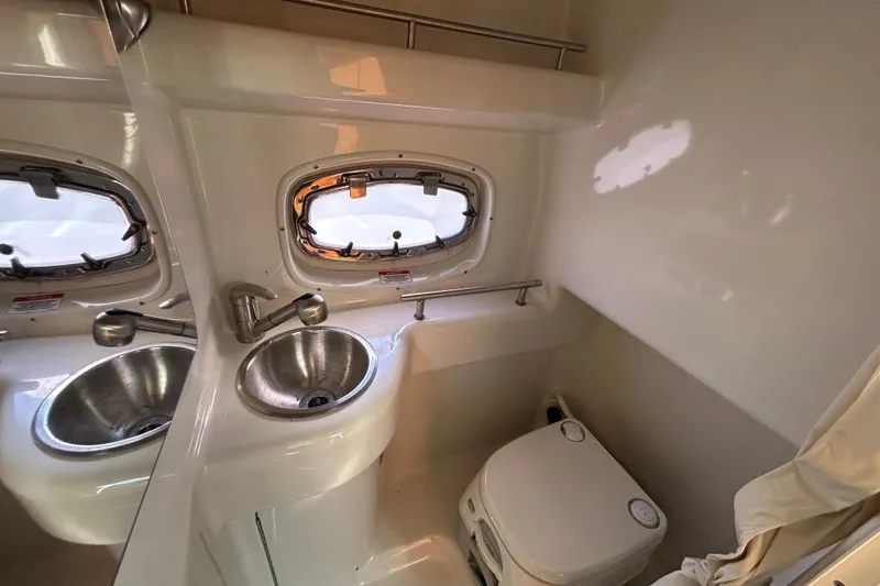 Slide: The Image of 2010 Sea Ray Sundancer 260 boat interior with sleek cabinetry and chrome handle. - 61