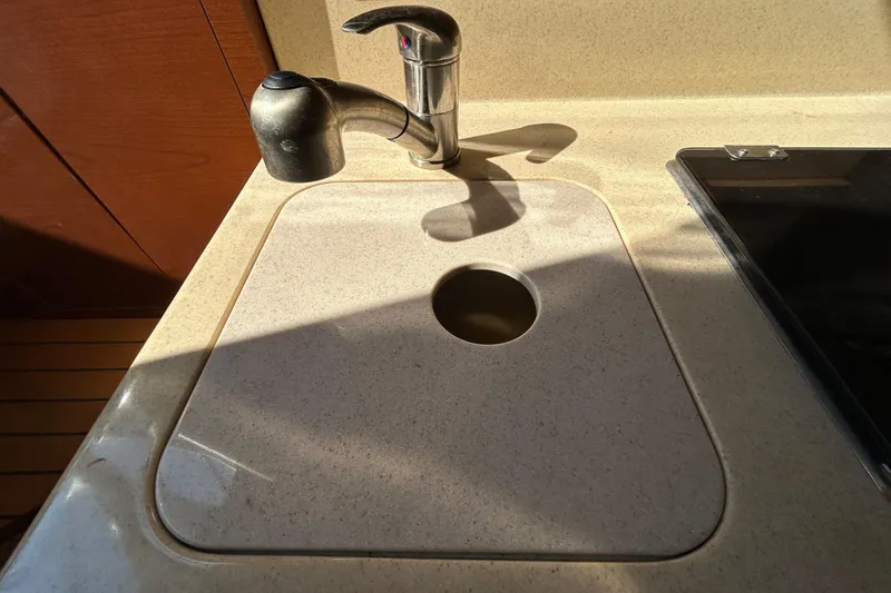 Slide: The Image of Control panel of a 2010 Sea Ray Sundancer 260 with switches and warning label. - 70