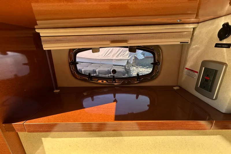 Slide: The Image of Hatch door on a 2010 Sea Ray Sundancer 260 boat, featuring a chrome handle. - 72