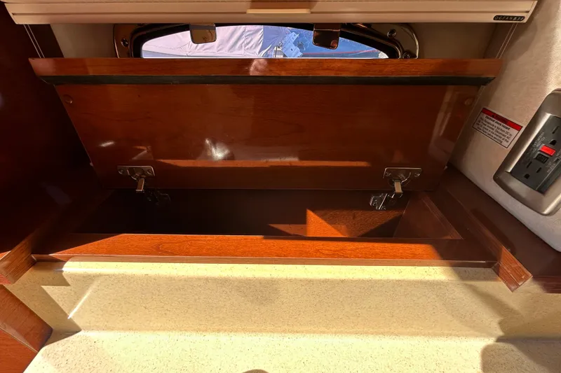 Slide: The Image of Storage compartment on a 2010 Sea Ray Sundancer 260 boat, showing interior details. - 73