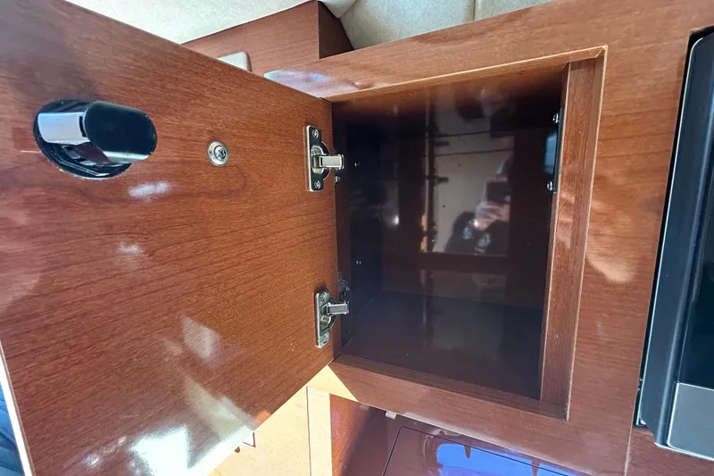 Slide: The Image of Electrical compartment of a 2010 Sea Ray Sundancer 260 boat, showing wiring and components. - 76