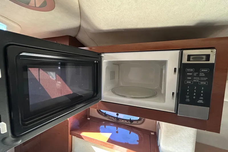 Slide: The Image of Interior of 2010 Sea Ray Sundancer 260 with fire extinguisher and cushioned seating. - 79
