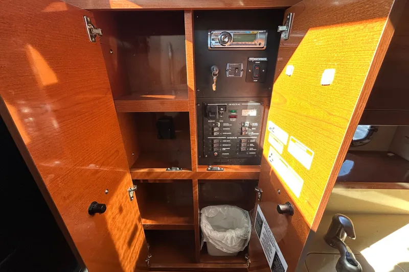 Slide: The Image of Hinged compartment door on 2010 Sea Ray Sundancer 260 boat interior. - 82