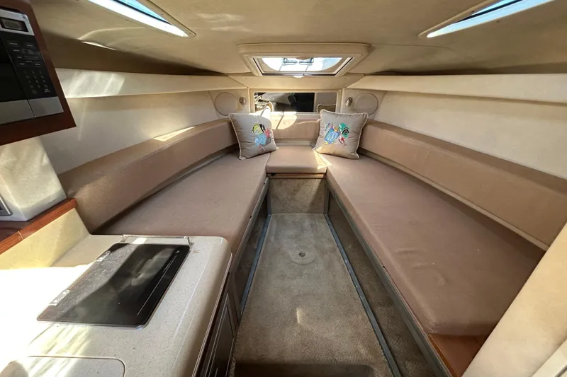 Slide: The Image of 2010 Sea Ray Sundancer 260 boat storage compartment with chrome handle and cushioned seating. - 85