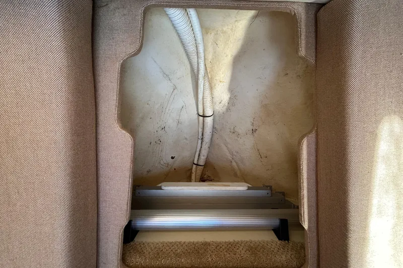 Slide: The Image of Open anchor locker on 2010 Sea Ray Sundancer 260 boat, docked by wooden posts. - 89