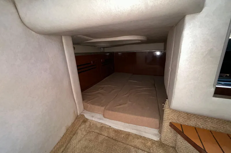 Slide: The Image of Interior of 2010 Sea Ray Sundancer 260 boat with beige seating and decorative pillows. - 91