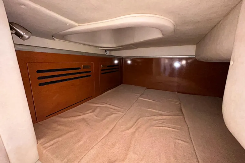 Slide: The Image of Interior cabin of 2010 Sea Ray Sundancer 260 with beige seating and compact kitchenette. - 92