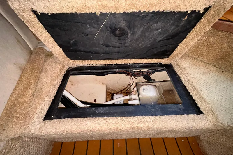Slide: The Image of Interior view of a 2010 Sea Ray Sundancer 260 boat compartment with visible wiring. - 95