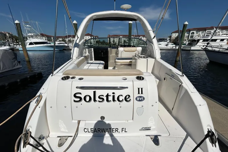 Slide: The Image of Interior cabin of 2010 Sea Ray Sundancer 260 with wood paneling and beige upholstery. - 98