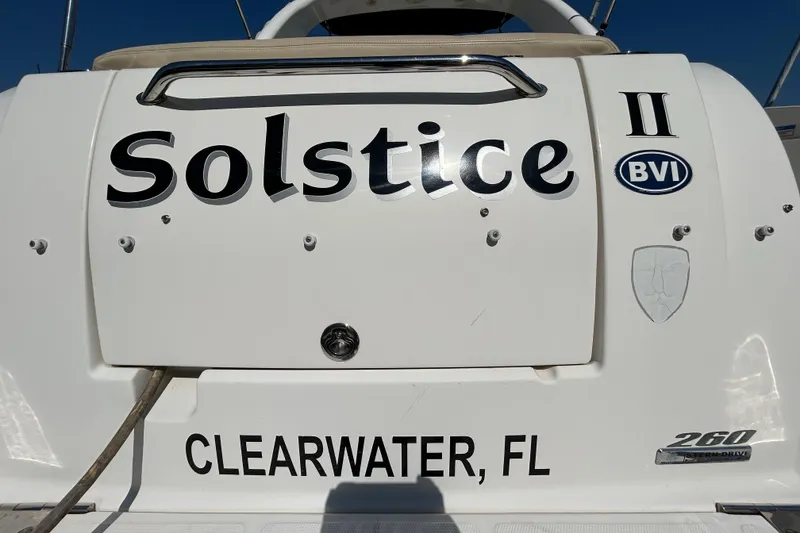 Slide: The Image of Interior cabin of 2010 Sea Ray Sundancer 260, featuring beige upholstery and wood paneling. - 99