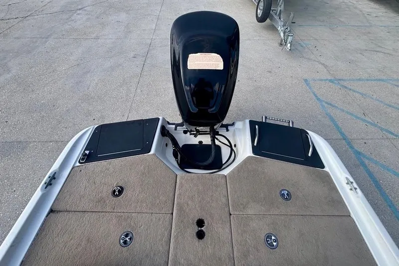 Slide: The Image of 2008 Ranger 180 Reata boat deck with motor, carpeted surface, and storage compartments. - 12