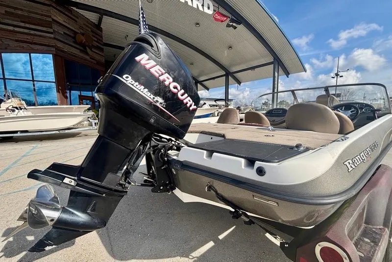 Slide: The Image of 2008 Ranger 180 Reata boat with Mercury OptiMax engine, parked outdoors. - 3