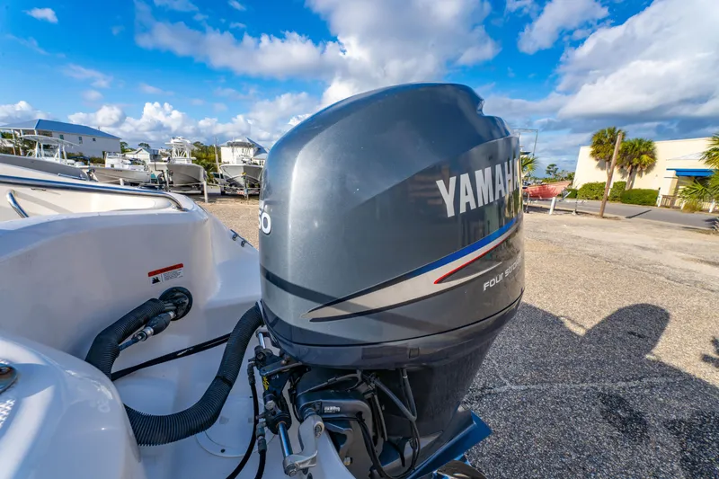 Slide: The Image of 2008 Wellcraft 180 Sportsman with Yamaha outboard motor in a sunny boatyard. - 10