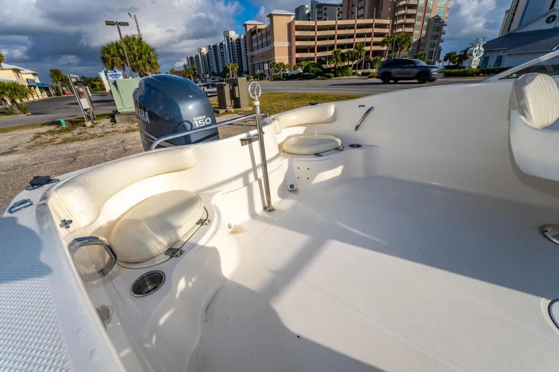 Slide: The Image of 2008 Wellcraft 180 Sportsman boat interior with Yamaha 150 engine, parked near buildings. - 13