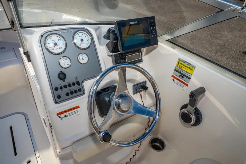 Slide: The Image of 2008 Wellcraft 180 Sportsman boat dashboard with steering wheel and navigation equipment. - 19