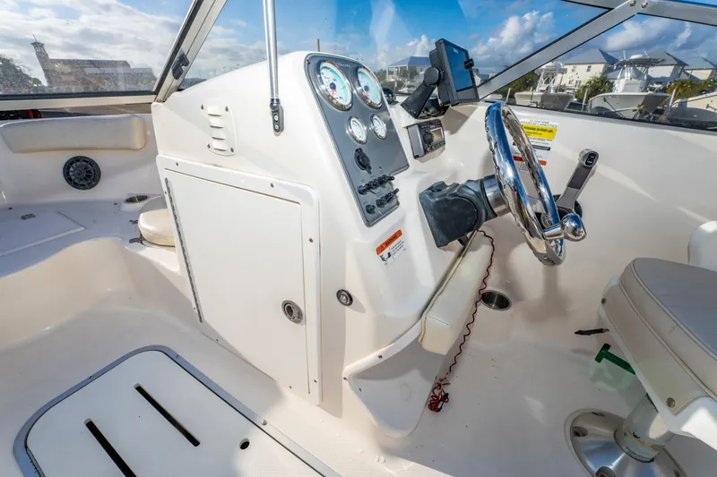 Slide: The Image of 2008 Wellcraft 180 Sportsman boat interior with Yamaha 150 engine, featuring cushioned seating. - 24