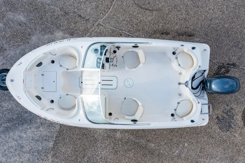 Slide: The Image of 2008 Wellcraft 180 Sportsman boat on trailer, parked near modern buildings under a blue sky. - 3