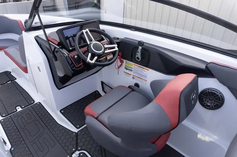 Slide: The Image of 2026 Scarab 255 LX Wake boat interior with modern helm and red-accented seating. - 17