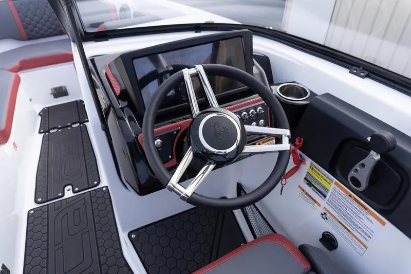 Slide: The Image of 2026 Scarab 255 LX Wake boat dashboard with steering wheel and control panel. - 18