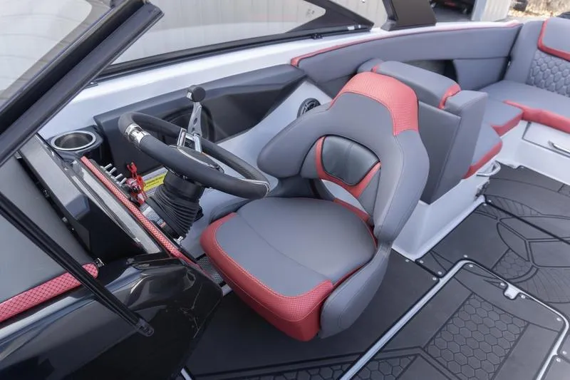 Slide: The Image of 2026 Scarab 255 LX Wake boat interior with red and gray seating, steering wheel, and modern design. - 24