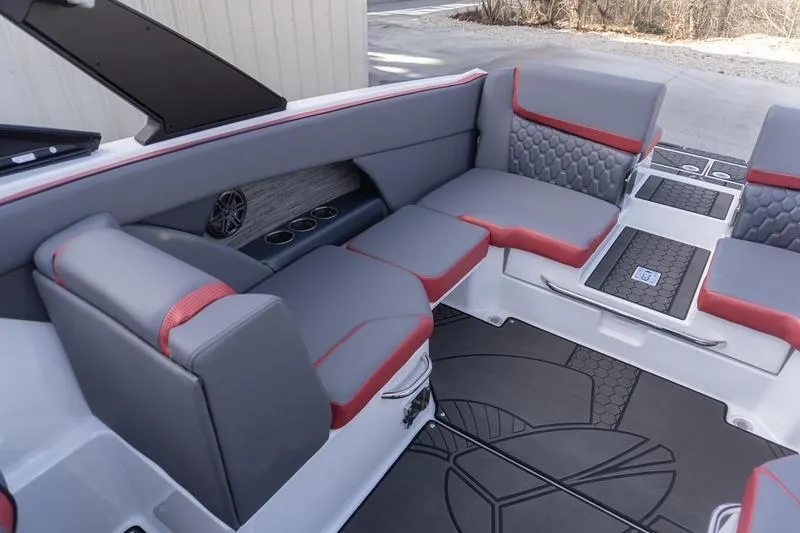 Slide: The Image of 2026 Scarab 255 LX Wake boat interior with gray and red seating, cup holders, and stylish flooring. - 26