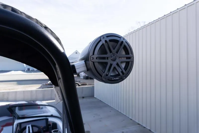 Slide: The Image of Speaker on 2026 Scarab 255 LX Wake boat, mounted on a metal frame. - 29